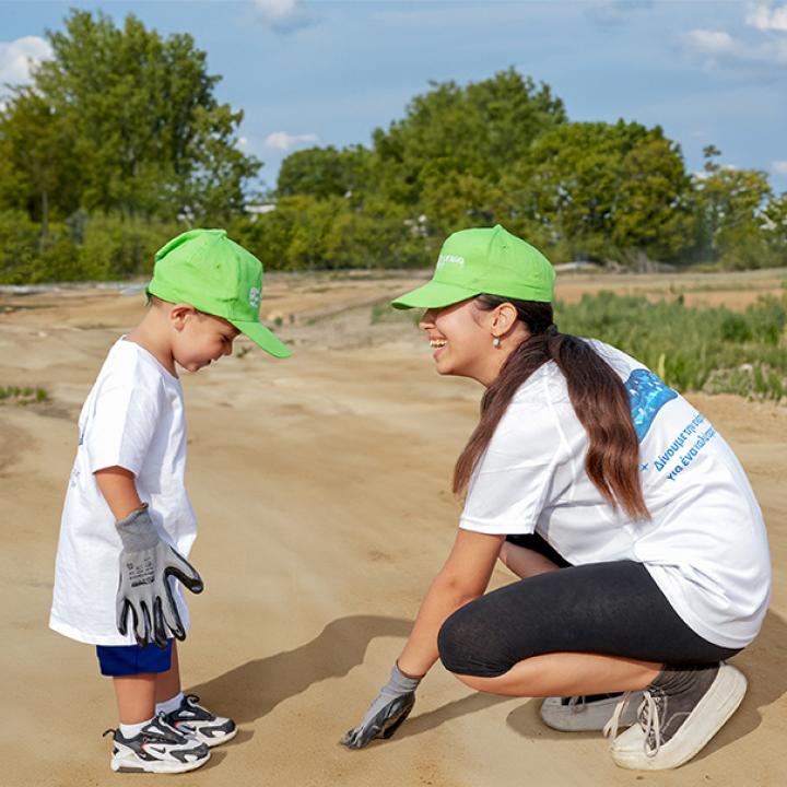 mum with child cleaning a beach